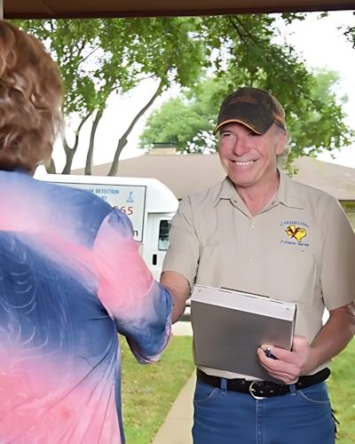 Licensed Carrollton plumber greeting a homeowner at the door before a service call